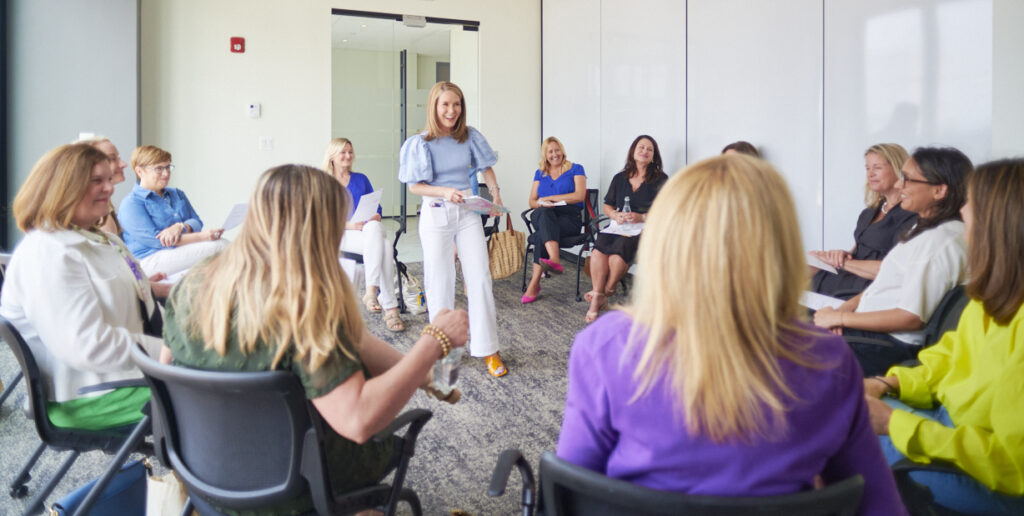 Adrien Cotton Speaking To A Group Of Women