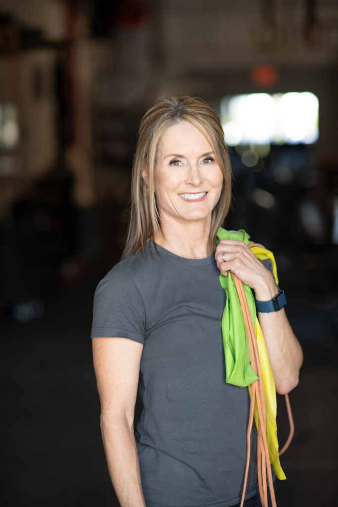 Adrien Cotton With Resistance Bands Slung On Her Shoulder