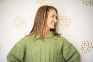 Fitness Expert Adrien Cotton, in green sweater looking to the right