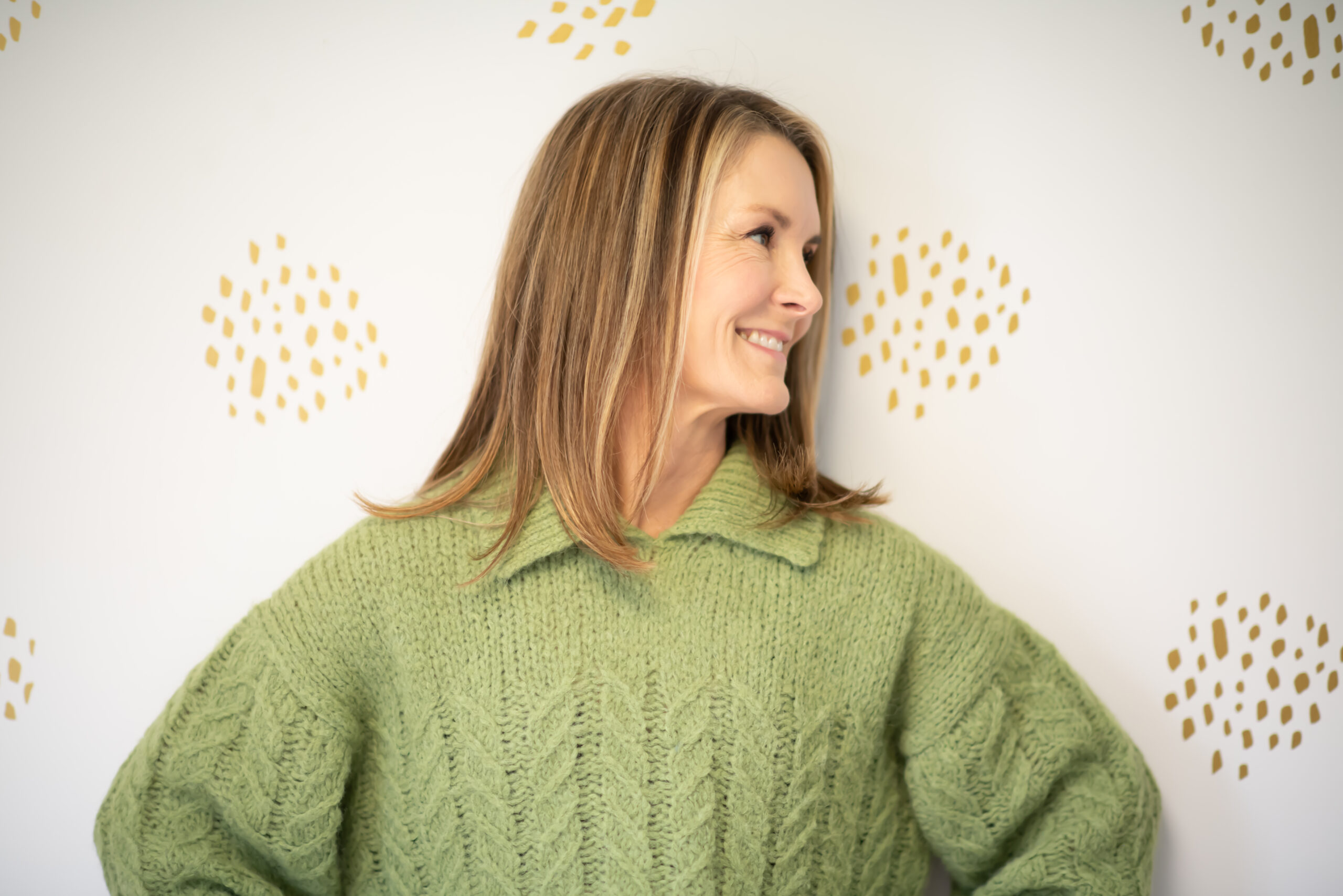 Fitness Expert Adrien Cotton, in green sweater looking to the right