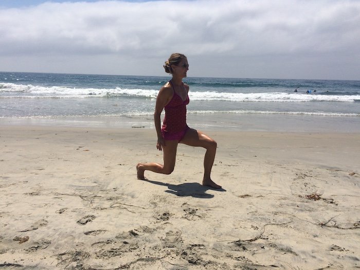 Adrien Cotton Of Alexandria Wellness Does A Lunge On The Beach