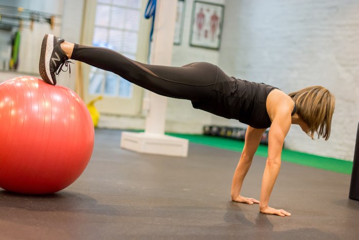 Adrian Cotton Doing A Plank With A Ball Under Feet.