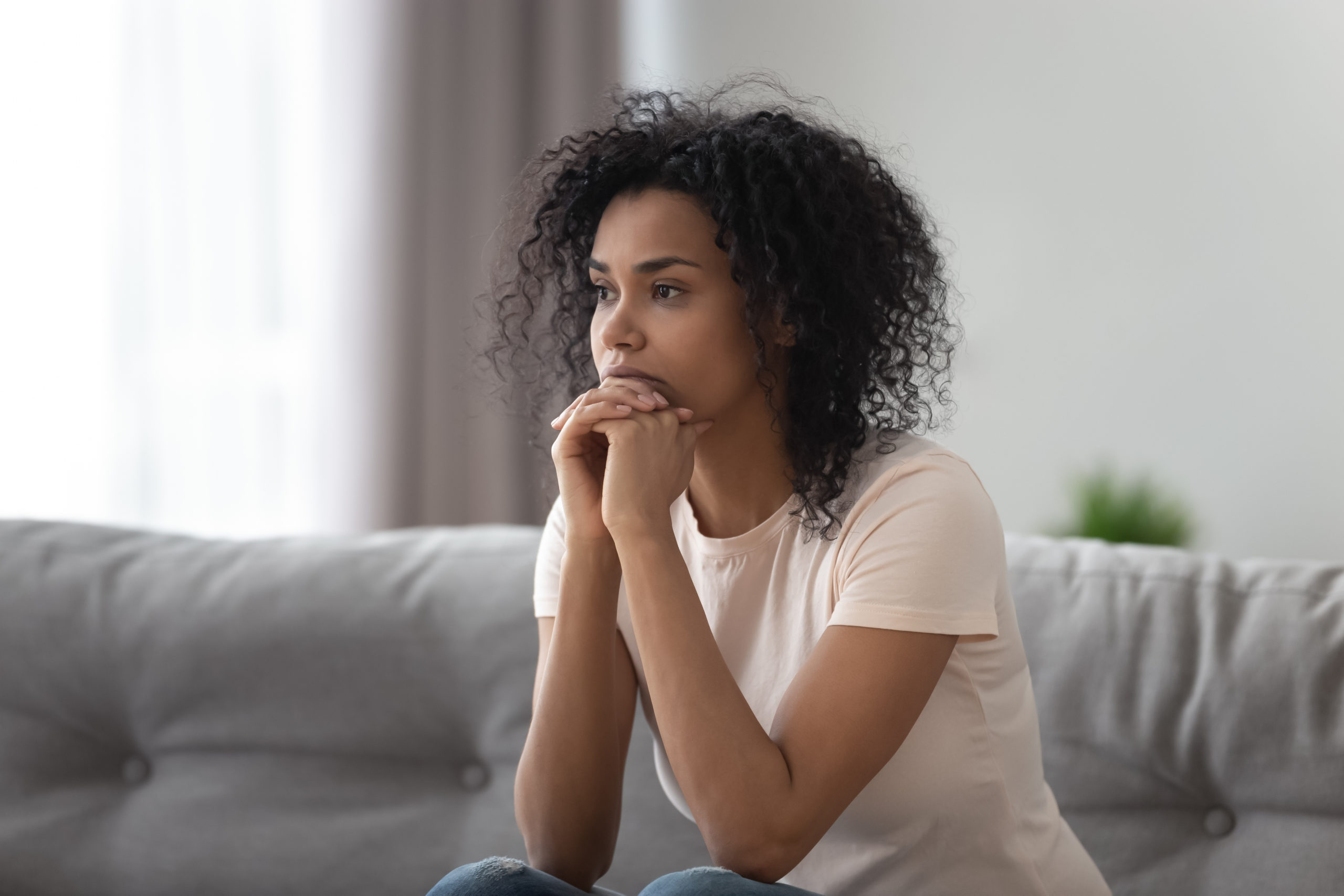 Worried Young Black Woman Sitting At Home