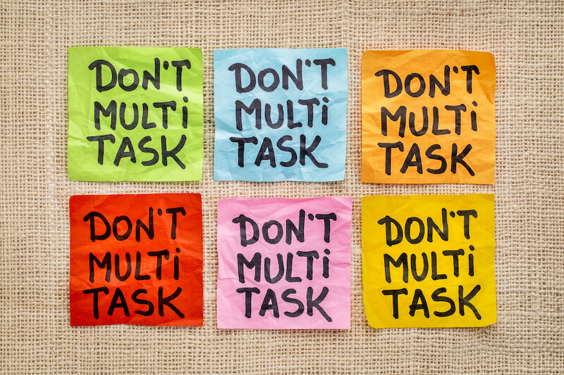 Several Multicolored Sticky Notes That All Say 'Don'T Multitask' In Bold Lettering.