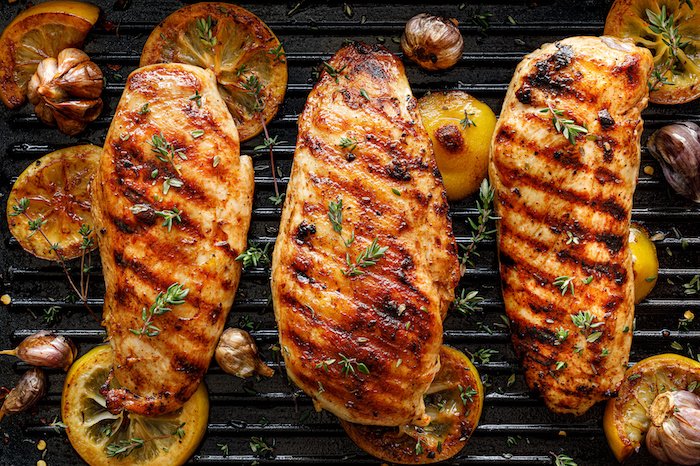 Grilled Chicken Breasts With Thyme, Garlic And Lemon Slices On A Grill Pan, Top View