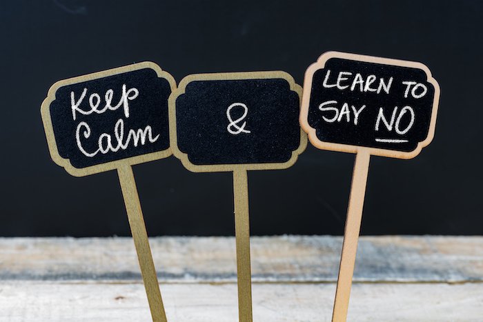 Keep Calm and Learn To Say NO message written with chalk on mini blackboard labels