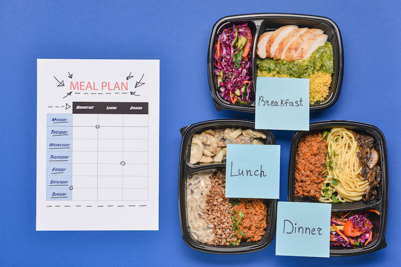 Containers With Healthy Food And Meal Plan On Color Background