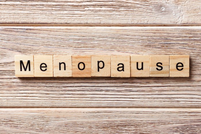 Menopause Written In Scrabble Letters On A Wooden Table