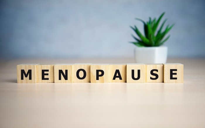 Menopause Written On A Desk In Wooden Scrabble Letters 