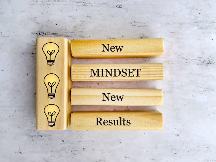 New Mindset New Results Quote On Wooden Blocks With Yellow Light Bulbs