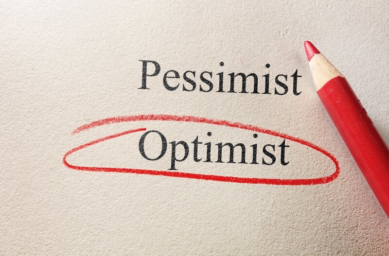 The Words Pessimist And Optimist Are Typed On A Piece Of Paper With Optimist Circled In A Red Pencil.