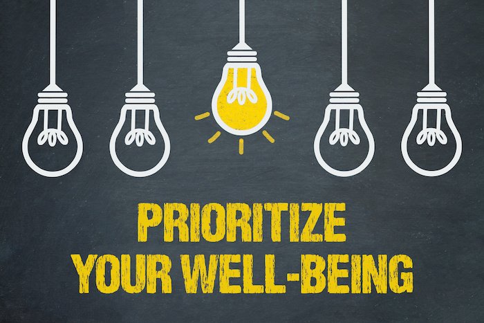 Graphic That Says &Quot;Prioritize Your Wellbeing&Quot; With Lightbulb Illustration