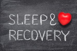 Sleep And Recovery Phrase Written On Chalkboard With Red Heart Symbol