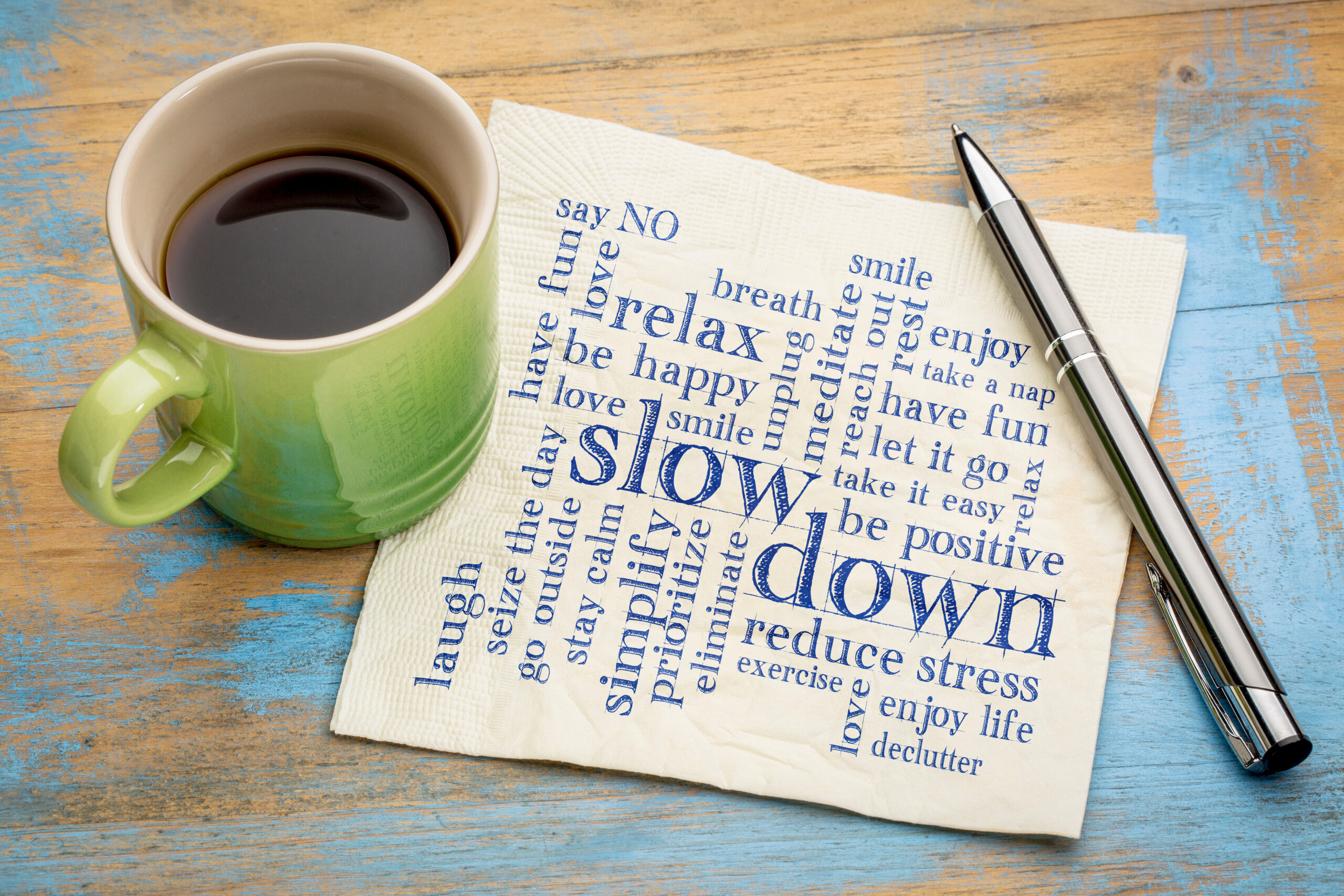 Slow Down And Relax - Reducing Stress - Tips In The Form Of A Word Cloud On A Napkin With A Cup Of Coffee