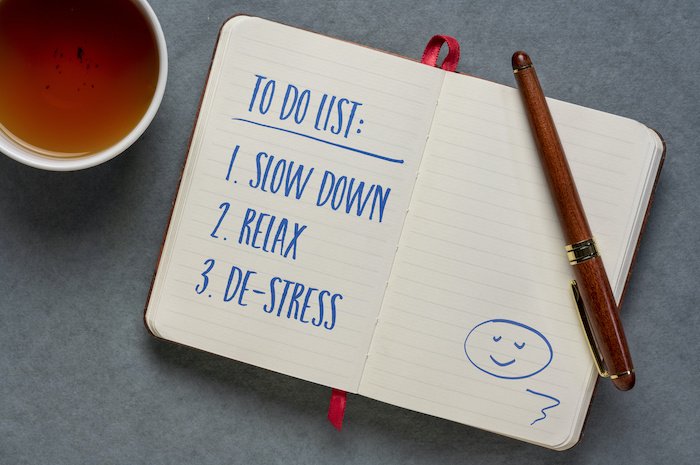 Notebook On A Table With A Cup Of Coffee- Written In It Is: To Do List - Slow Down, Relax And De-Stress