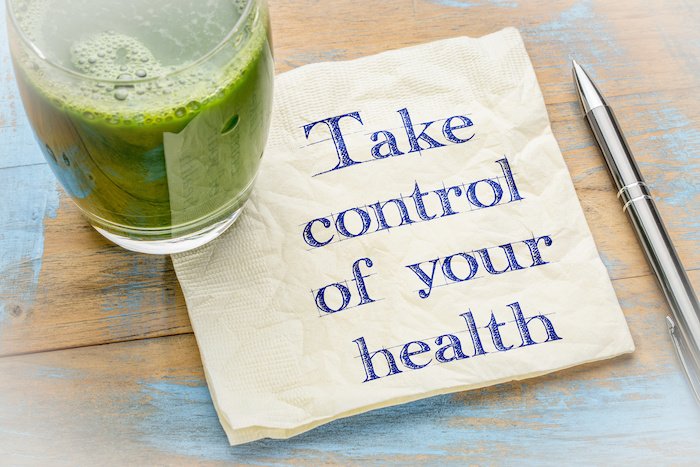 Take Control Of Your Health Written On A Napkin With A Green Juice And Pen Nearby