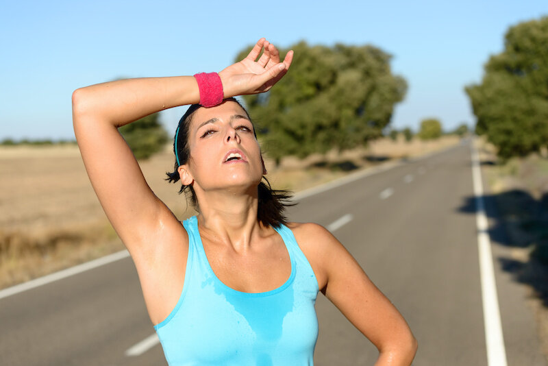 Tired Woman Sweating After Running