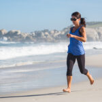 Woman Running Barefoot On The Beach - How To Hold Your Hands When You Workout
