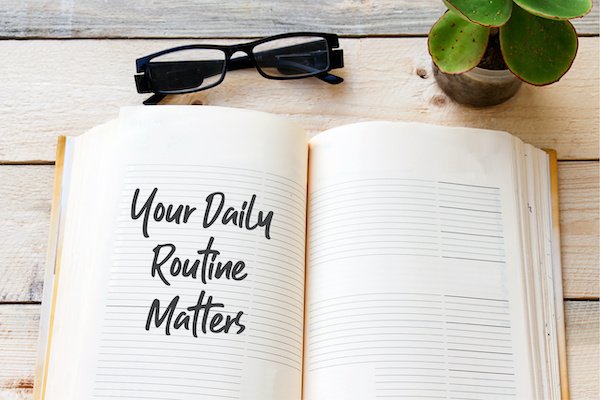 &Quot;Your Daily Routine Matters&Quot; Written In A Notebook. 