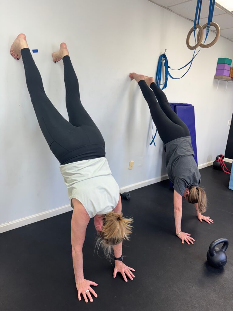 Adrien And Community Doing Handstands Against A Wall